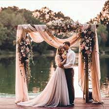 A romantic wedding arch with flowers and beads. 10 Best Wedding Arch Styles Of All Time