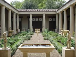 A courtyard with statues and grass