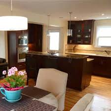 Carved, painted, inlaid with gold, or minimalistic flat panels are some of the varieties of dark wood style cabinetry you'll see in this collection. Revitalized Open Concept Kitchen