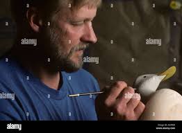 USA Maryland Tilghman Island MR Decoy carver Dan Vaughan paints waterfowl  decoy in his workshop Stock Photo