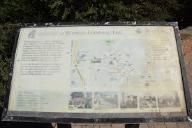 On the Greenway Trail at the Palm Park Station there are two features: The  colorful, handmade birdhouses and the arbor with the wooden columns from  the former Fred C. Nelles School building.