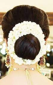 What A Beautiful Large Low Bun With Real Flower Gajra Care However Should Be Taken Before Adopti Low Bun Wedding Hair Flowers In Hair Wedding Hair Inspiration