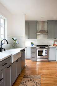 Grey kitchen cabinets with black hardware. Busy Professionals With Two Young Kids Liz Flynn And Craig Howe Lived In Their 1927 Silver Lak Kitchen Remodel Layout Kitchen Remodel Plans Kitchen Renovation