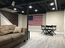Finished, functional industrial basement with exposed ductwork. 20 Stunning Basement Ceiling Ideas Are Completely Overrated Basement Living Rooms Basement Ceiling Basement Ceiling Painted