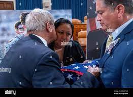 Rep. Joe Wilson, R-S.C., kisses Alicia Lopez, mother of Marine Corps Cpl.  Hunter Lopez, an Abbey Gate Gold Star family member, as he presents her and  her husband Herman Lopez with a
