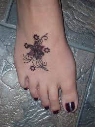 Flower tattoo is one of the favorite tattoos of women, and i think it is also one of the most suitable elements for designing female tattoos. Grey Flower And Stars Tattoo On Girl Right Foot