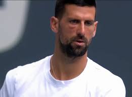 Djokovic's eye is pretty swollen as he warms up for the Miami Open final  against Mensik…