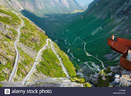 Die größte aussichtsplattform ragt über eine kante und schwebt 200 meter über dem trollstigen, der sich den steilen berghang in serpentinen hinaufschlängelt. Touristen Auf Der Aussichtsplattform Hohe Bergstrasse Trollstigen Norwegen Stockfotografie Alamy
