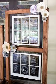 Acrylic Seating Chart Displayed In Hanging Vintage Windows With Paper Flowers Wedding Place Cards Seating Chart Wedding Custom Wedding Invitations