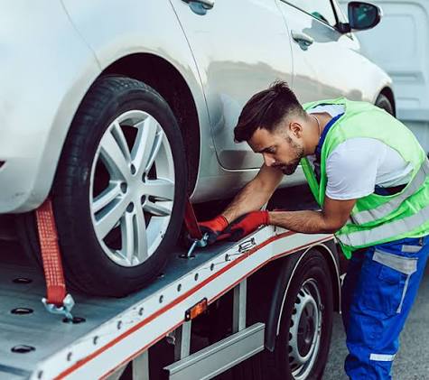 Mechanic performing breakdown recovery on a vehicle at the roadside