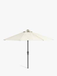 This garden table umbrella set includes a stylish, wicker and glass table, which forms the unique garden parasol base. John Lewis Parasols John Lewis Partners
