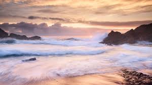 Sunset wave crashing on a beach. Waves Crashing On A Beach At Sunset Beaches Nature Background Wallpapers On Desktop Nexus Image 2090730