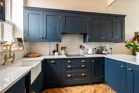 Dark blue kitchen cabinets with brass hardware. Old Windsor Kitchen Herringbone Kitchens