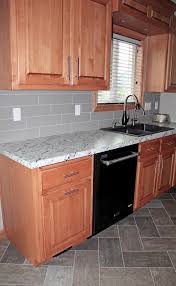 Maple Cabinets Gray Backsplash Tile Herringbone Tile Flooring Maple Cabinets Black Granite Countertops Kitchen Flooring