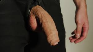 Thick uncut dick growing in black jeans. Natural foreskin. Cum on black  plate.