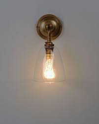 Takes four maximum 60 watt standard base bulbs (not included). Clear Glass Wall Light Pixley Industrial Modern Designer Contemporary Retro Style Wall Lights Antique Brass Wall Lights Contemporary Wall Lights