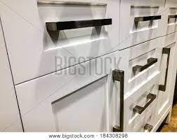 Maybe you would like to learn more about one of these? White Kitchen Cabinets Modern Base Cabinets With Chrome Cabinet Handles Modern Cabinets Contemporary Italian Kitchen Cabinet Design Base Doors And Drawers Of Wooden Kitchen Cabinet Stock Images Page Everypixel