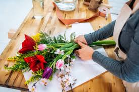 Each rose flower bouquet has 9 heads. From Above Cropped Unrecognizable Female Florist In Casual Clothes And Apron Arranging Elegant Bouquet Of Assorted Flowers In Store Stockphoto