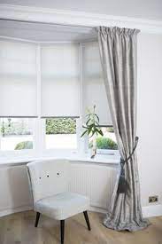 They let in a lot of light and act like a dramatic centrepiece in any room they are installed. Blind With Curtain Ideas Google Search Bay Window Living Room Bay Window Bedroom Bedroom Window Dressing