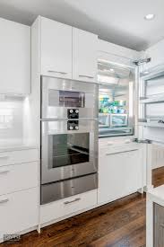 Make the legs yourself or purchase prefabricated legs (just make sure you measure the height from floor to bottom of cabinet) then install them beneath the cabinet in the toe kick space. Boston Newton Contemporary Leicht Kitchen Gaggenau Divine Design Build