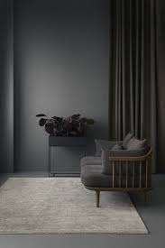 Monochromatic Wall And Furniture Dark Charcoal Grey Wallpaint And Lounge Chair And Tall Planter With Images Dark Grey Living Room Living Room Grey Interior Design