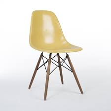 These chairs boast a plastic seat and wooden legs with metal supports. Ochre Herman Miller Original Eames Dsw Dining Side Shell Chair 101750