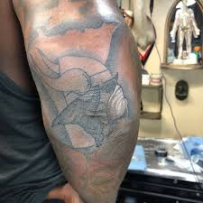 The last thing he remembered before being abducted by aliens was tattooing a strange hieroglyph on a suited man located somewhere in the middle of a field near the outskirts of. The Checkdown On Twitter Linval Joseph Got A Tattoo Of The Vikings Logo Featuring His Infamous Oxygen Mask Via Biggoon98 Ig