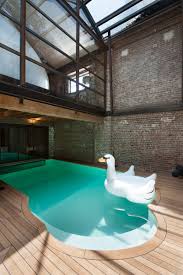 This Warehouse To Living Conversion Includes A Sculptural White Pod With A Hidden Bedro Indoor Swimming Pool Design Indoor Swimming Pools Swimming Pool Designs