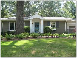 The greige trim helps unite the dark gray brown exterior brick with the black shutters and white vinyl windows. Ranch Redo Colors Ranch House Exterior Painted Brick House Brick Ranch Houses