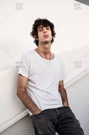 For anyone who likes cute guys! From Below Handsome Confident Dark Haired Man In Casual Clothes Looking At Camera Against White Wall Stock Photo Offset