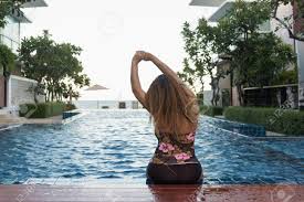 Pool lounge chairs are sturdy, durable, and soft, and they also allow you to bask in the ambiance of your backyard. Woman Sitting On Swimming Pool In Tropical Beach Resort With Stock Photo Picture And Royalty Free Image Image 76997749