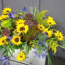 Floral Design By Lilies White Casket Spray Featuring Sunflowers Dried Pods Fresh Moss Iris And Agapanthus Memorial Flowers Sympathy Flowers Funeral Floral