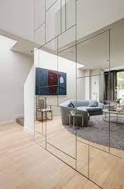 Mirrors make for great decor in a bedroom. Making Mirrored Walls Modern Seven Ideas To Steal Mirror Design Wall Mirror Wall Living Room Mirror Wall Tiles