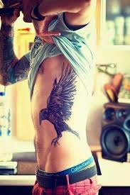 American eagle tattoos for women | tattoo of an eagle and indian face on a rib cage. Top 41 Best Rib Tattoo Ideas 2021 Inspiration Guide