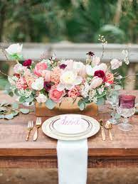 Long reception table with red flower arrangements. Wedding Table Settings That Make For A Beautiful Reception Wedding Table Settings Wedding Table Reception Table Settings