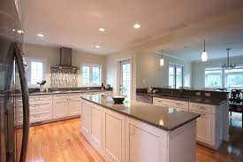 Stain it the same color as your cabinets. White Kitchen Oak Floors Traditional Kitchen Dc Metro By Nvs Kitchen And Bath Houzz