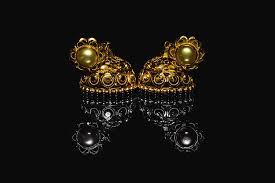 This stock motion graphics video shows a luminous liquified black glass showing colorful hues. Earring Gold Jewelry Traditional With Stones And Two Golden Earrings With Reflection Pair Of Golden Earring With Pearl Tone On Black Background Luxury Female Jewelry Close Up Jewelry By Srinivasan Jayaprakash
