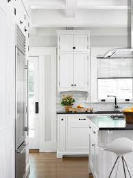 Using a white lacquer paint or finish on your existing cabinets makes them gleam, emphasizing the sleek and clean aesthetic. White Shaker Cabinets With Oil Rubbed Bronze Pulls Transitional Kitchen