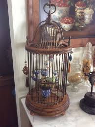 The brass bird cage has some dark spots on it, but the greenery and books are in great shape. Birdcage Cage Decor Bird Cage Decor Bird Cage