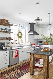 The wood kitchen island countertop, desaturated green/gray cabinets, oversized farmhouse sink, and black paneled window frames give this space a laid back feel. 60 Best Farmhouse Style Ideas Rustic Home Decor