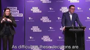 Laptop computer and microphone at podium. Ash Williams Daniel Andrews Press Conference Facebook