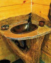 The corner pedestal sink was made for the small bathroom. Log Home Pedestal Sink Shaped Like A Log The Log Homes Guide House And Home Magazine Cabin Bathrooms Log Home Living