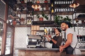 Coffee Shop Workers Standing At The Counter Coffee Shop Coffee Shop Photography Coffee Shop Logo