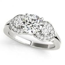 The two velvety sapphire side stones complement the bright diamond center stone. E2835514 Unique Design Diamond Three Stone Engagement Ring Tdn Stores
