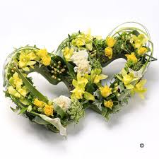 Two hearts intertwined, based with white chrysanthemums with a spray of red naomi roses and hypericum. Heart Double Heart Fleurtations Flowers