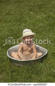 Smiling baby taking bath and playing with toys. Little Baby Girl Taking Bath Outdoors On The Grass In Vintage Washing Up Bowl Hygiene Hardening Nature Canstock