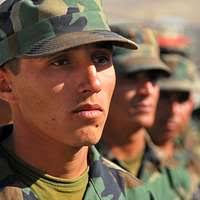 Pfc. Tyler Allen (background), a medic with Company