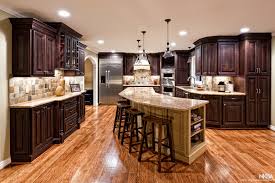 #kitchencabinets brazilian cherry floor, cherry cabinets with mix of natureal stain and black glaze, magma granite, cherry bar. Large Kitchen Remodel With Dark Cabinets And Cherry Floors Nkba