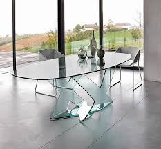If the table is airy up top and heavy down below, the chairs are the inverse: Dining Table In Curved Glass For Modern Living Room Idfdesign