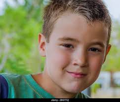 Close up face.Portrait of a cute boy with blonde hair and smile Stock Photo 